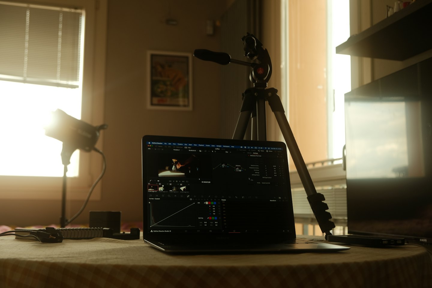 Laptop with video editing software open on a checkered table.
